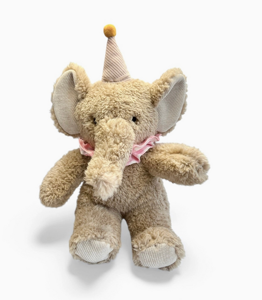 Plush elephant toy with a pink bow and yellow hat on a white background