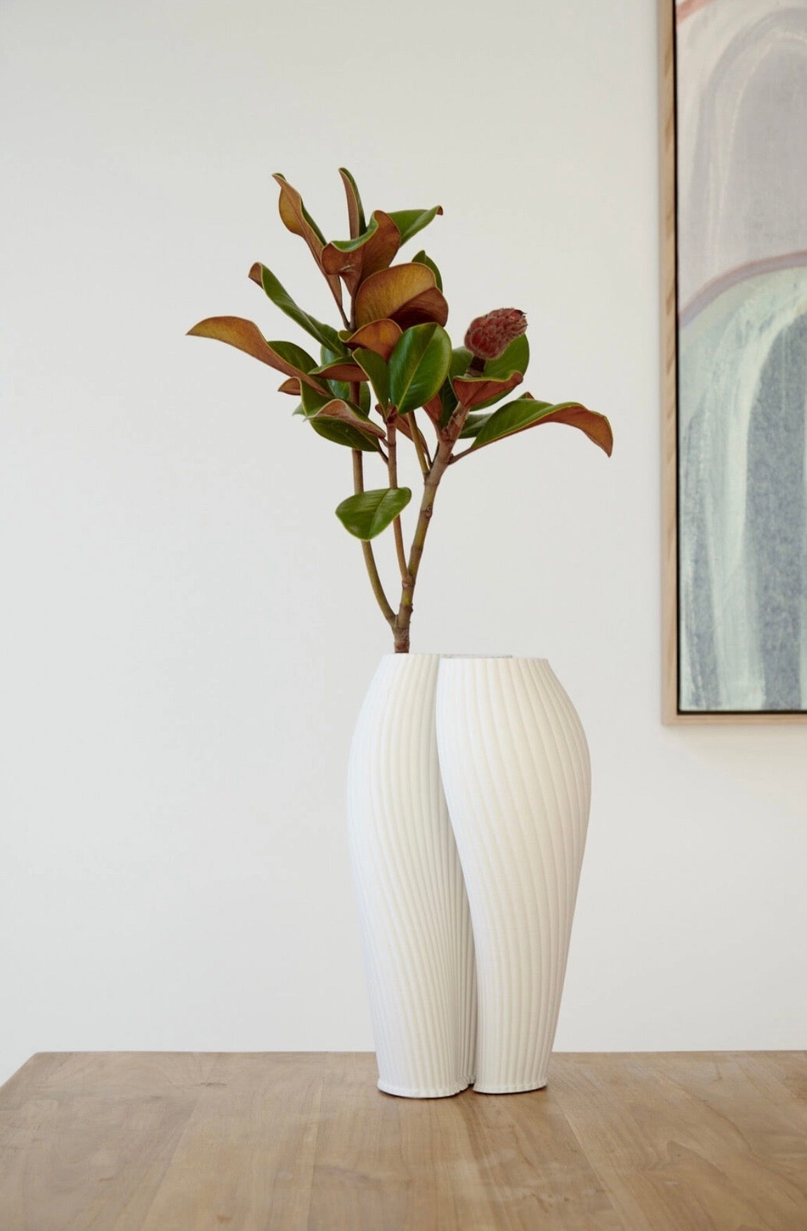 White ceramic vase with textured surface on a white background