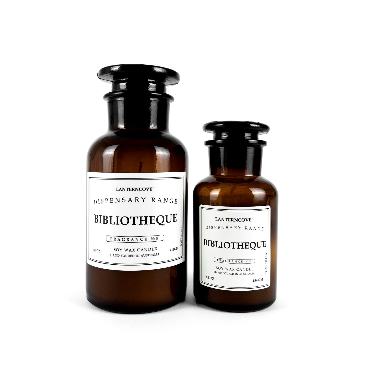 Two amber glass apothecary-style soy wax candles with black caps and white labels from Lanternove Dispensary Range, shown on a white background.